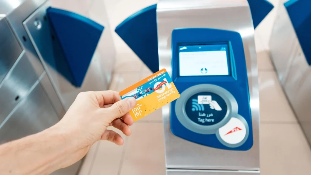 Person tapping Nol card at Dubai Metro gate
